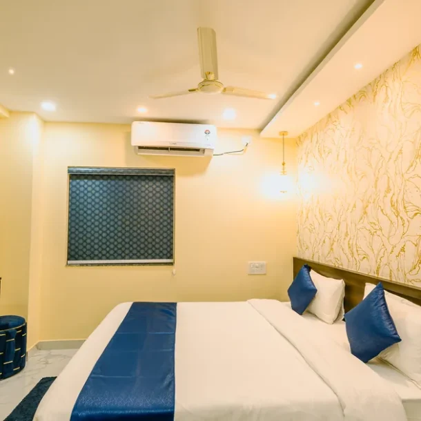 Air-conditioned room at Livotel Premium Hotel, Patia, with king-size bed and wall-mounted smart TV