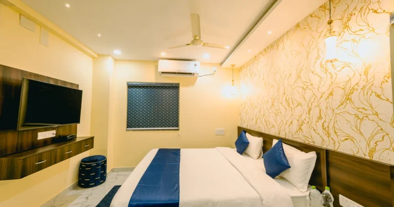 Air-conditioned room at Livotel Premium Hotel, Patia, with king-size bed and wall-mounted smart TV