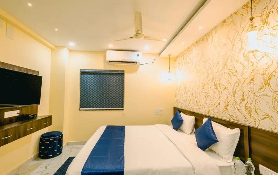 Air-conditioned room at Livotel Premium Hotel, Patia, with king-size bed and wall-mounted smart TV